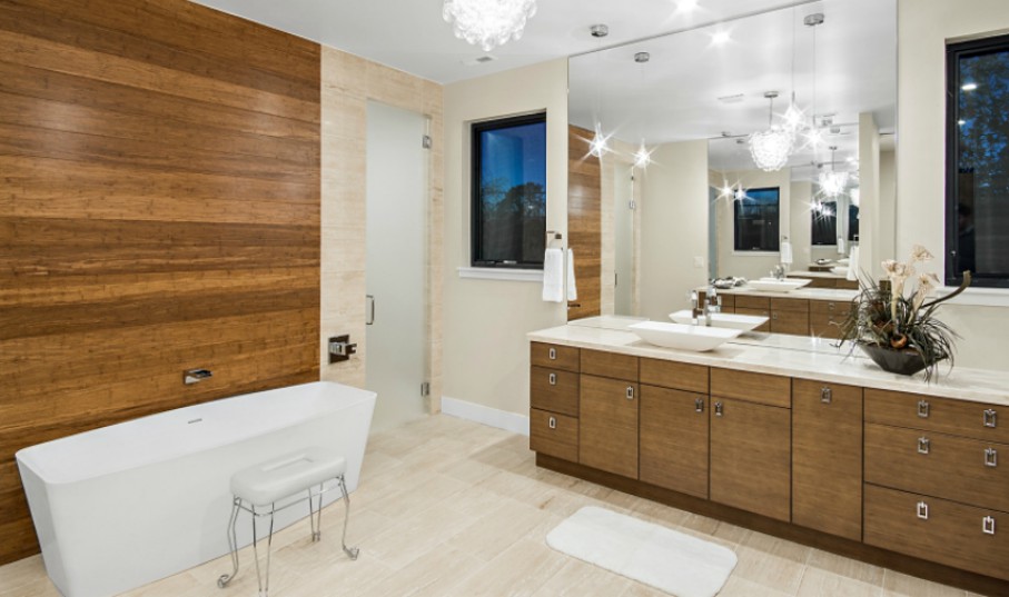 Master bathroom with modern cabinets and wooden accent wall