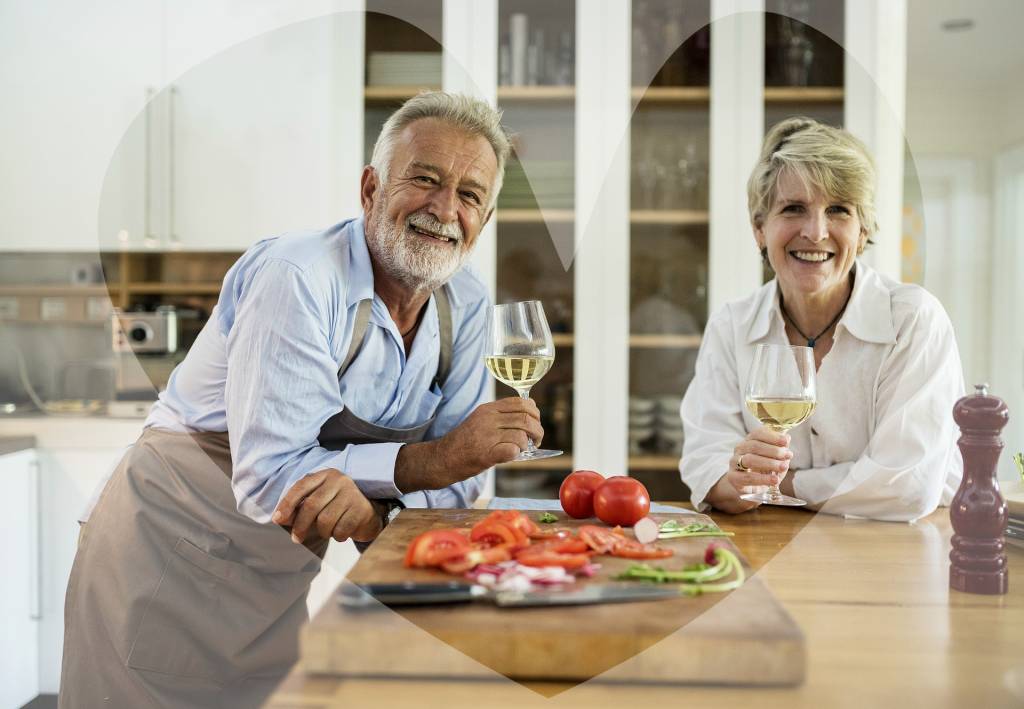 Older couple enjoying wine in their new kitchen