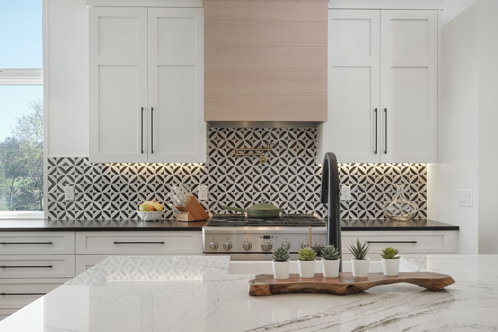 Kitchen remodel with white Shaker cabinets and tile backsplash