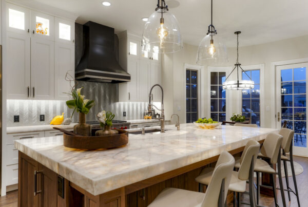 Remodeled kitchen with white Shaker cabinets and underlit countertops