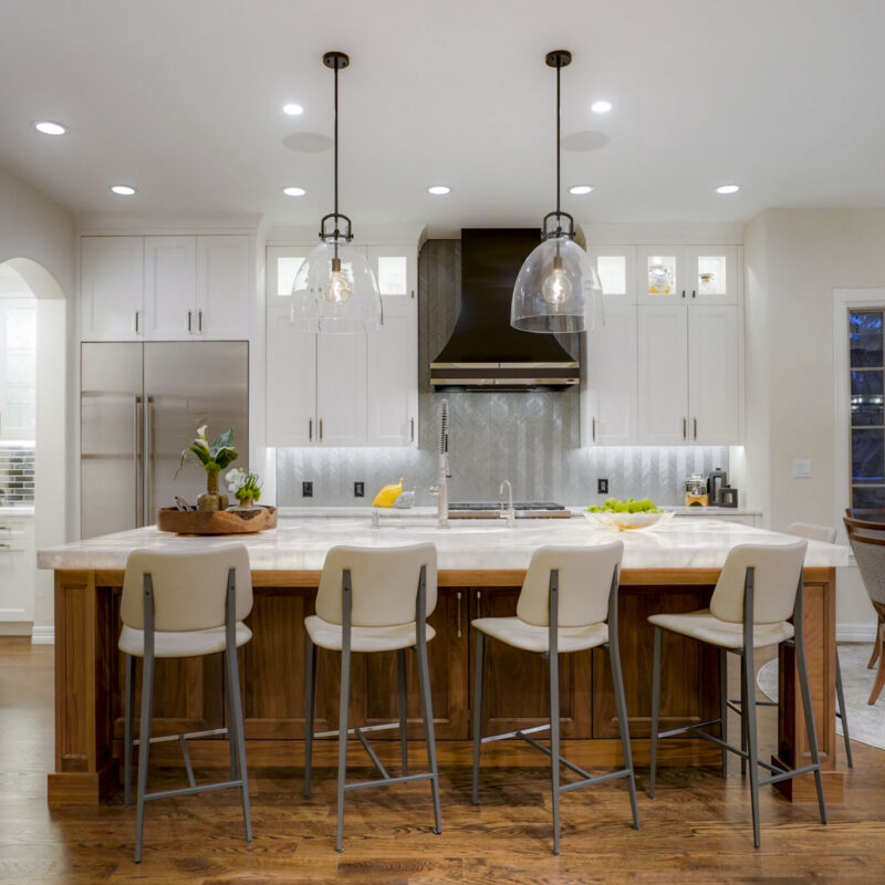 Remodeled kitchen with white Shaker cabinets and underlit countertops