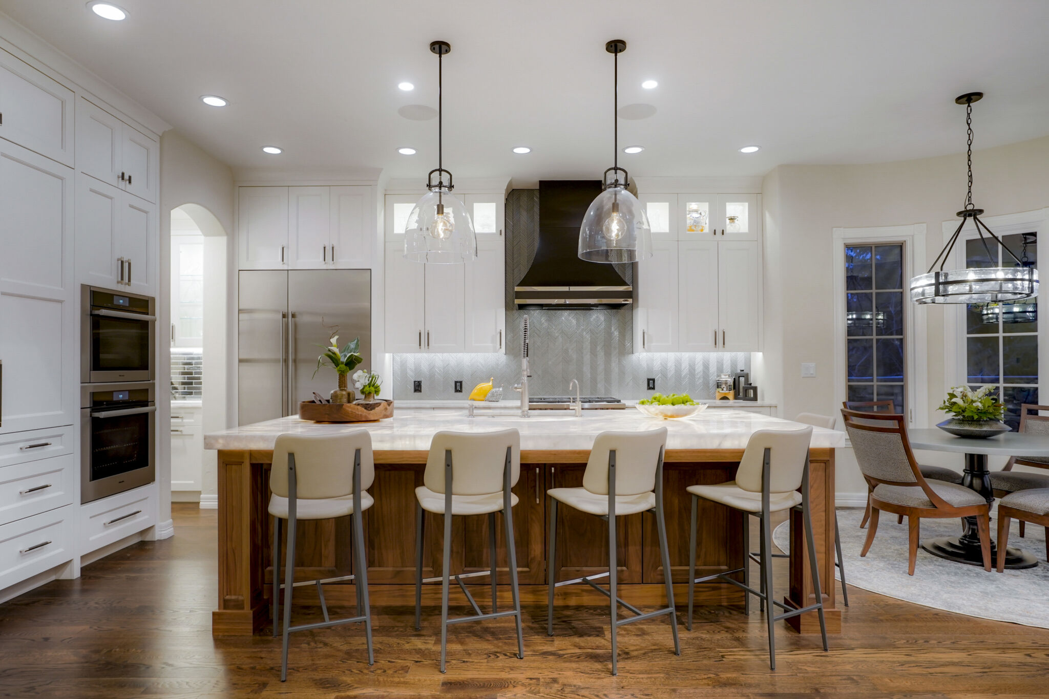 Remodeled kitchen with white Shaker cabinets and underlit countertops