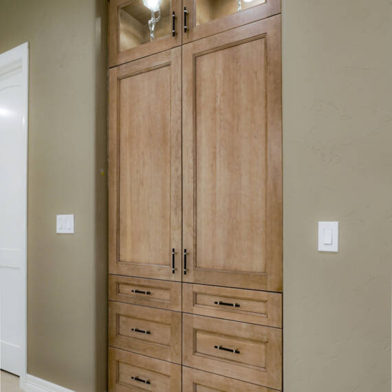 Built-in linen closet with cherry cappuccino cabinets