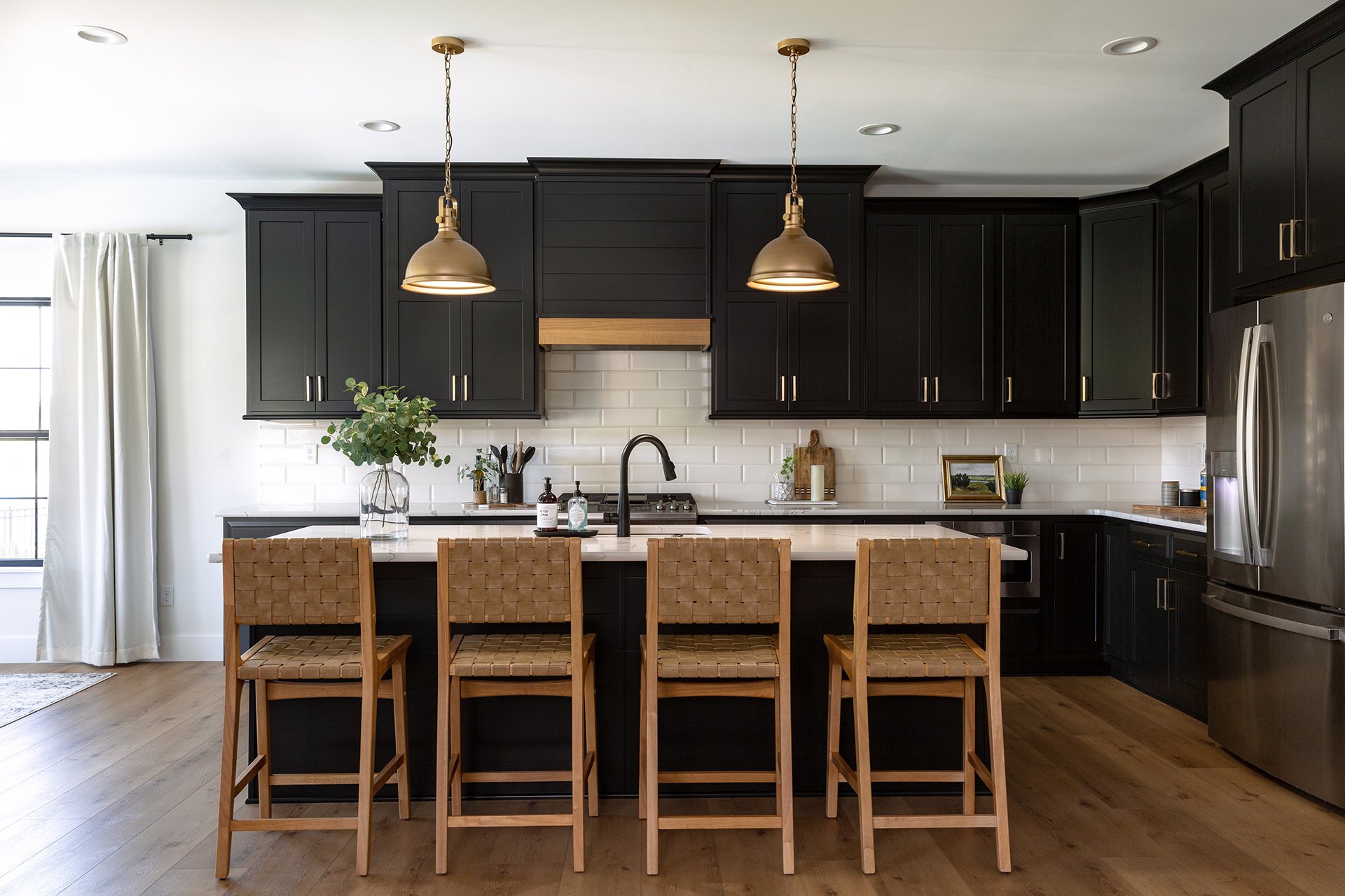 Black kitchen cabinets with natural wood accents