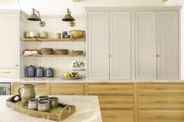 Kitchen with white painted and natural wood cabinets with open shelves