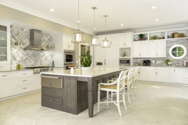 Kitchen with cream painted cabinets and dark wood island