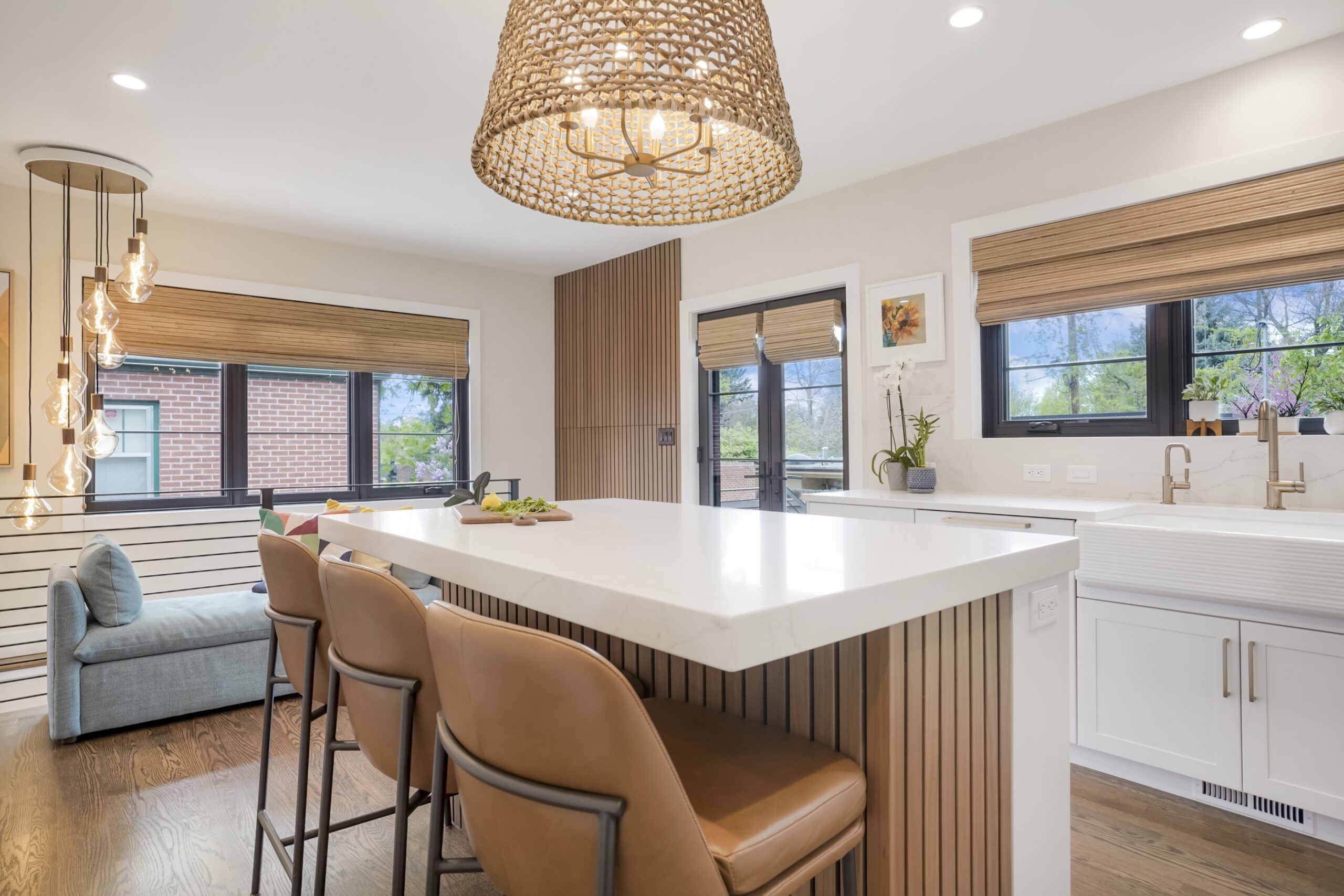 Contemporary kitchen featuring white shaker cabinets and slatted walnut elements. 