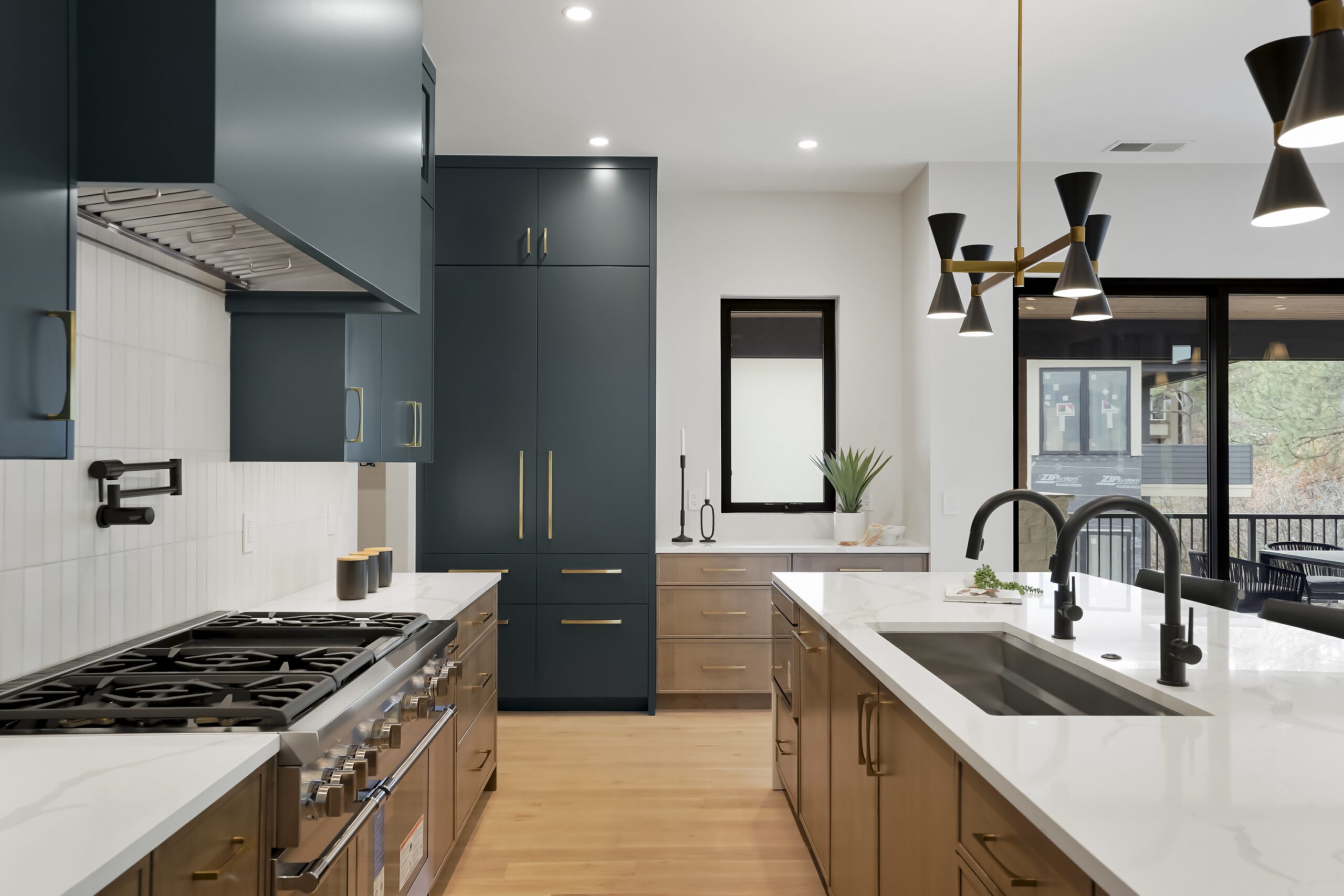 Modern kitchen by BKC Kitchen and Bath featuring dark green natural wood custom cabinets.